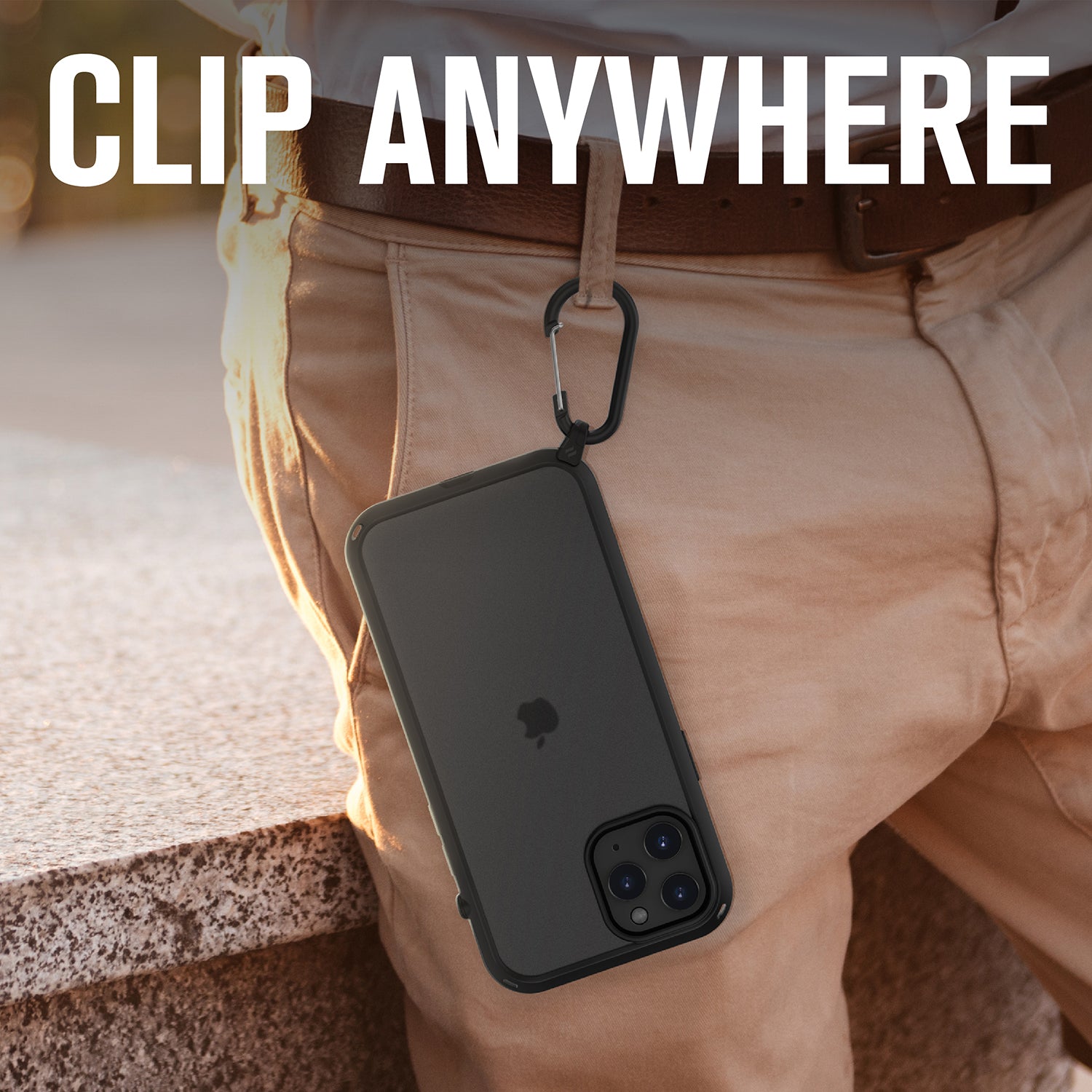 Catalyst carabiner attachment attached on pants with iPhone hanging Text reads clip anywhere
