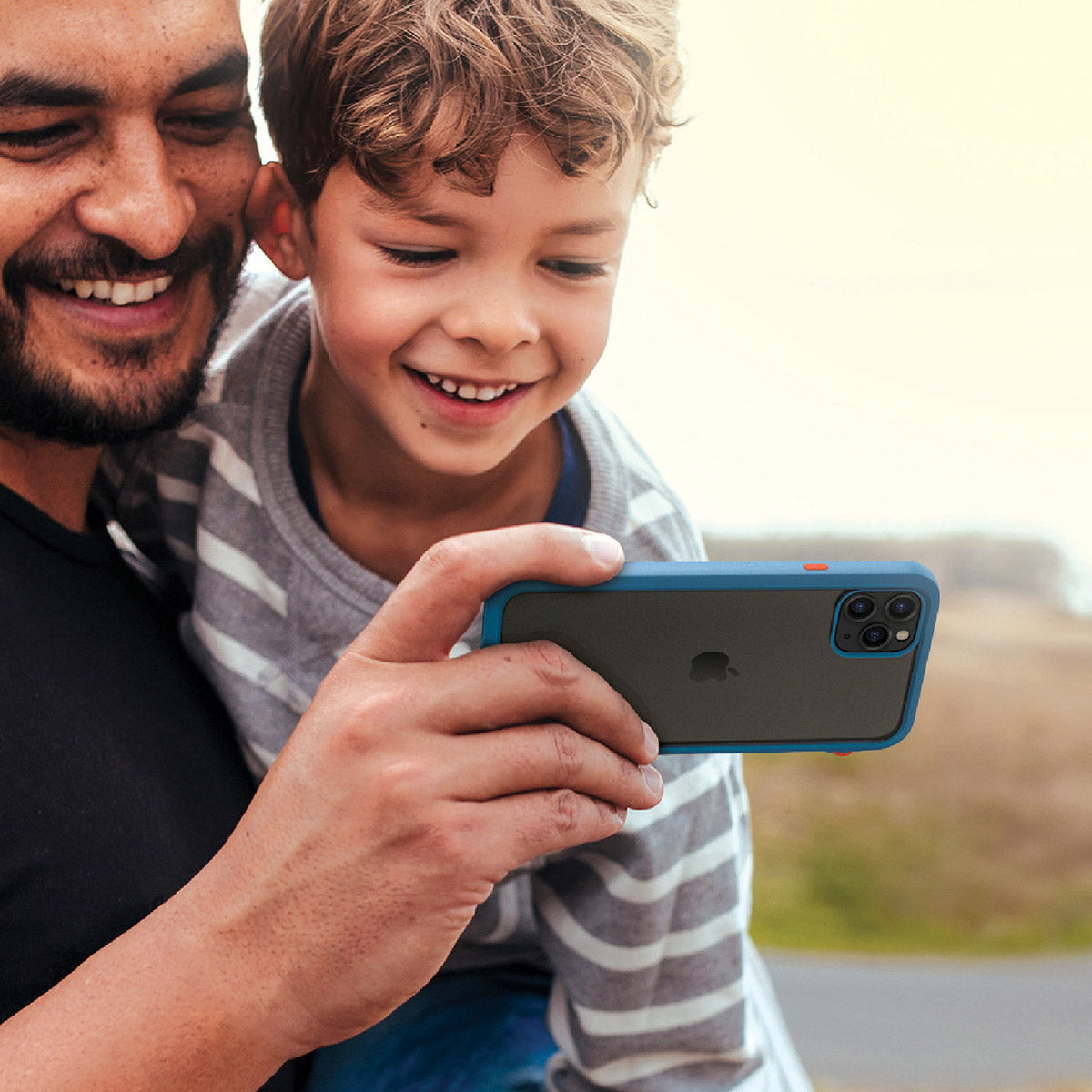 catalyst iPhone 11 series impact protection case father and son using iPhone 11 pro max with blueridge sunset case
