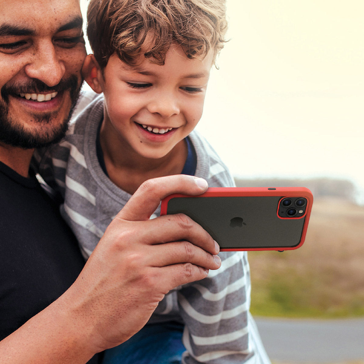 catalyst iPhone 11 series impact protection case father and son using iPhone 11 pro max with flame red case