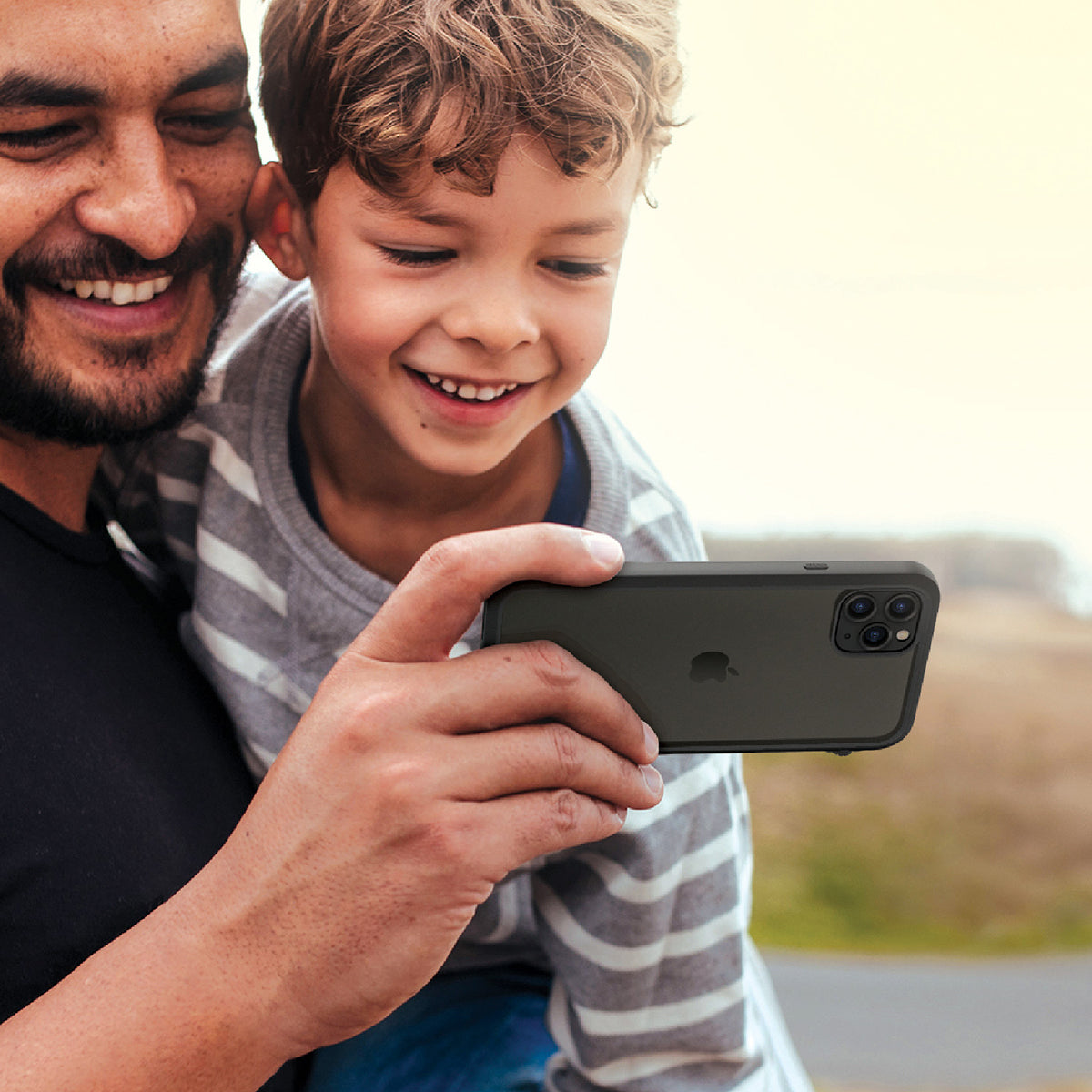 catalyst iPhone 11 series impact protection case father and son using iPhone 11 pro max with stealth black case