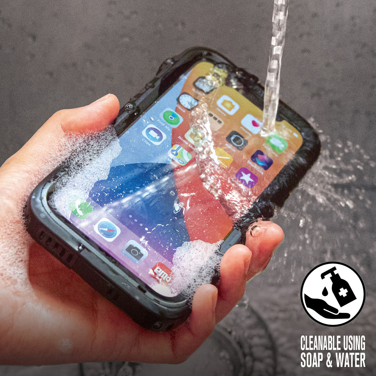 Catalyst iPhone 12 waterproof case total protection showing water being poured to phone Text reads cleanable using soap and water