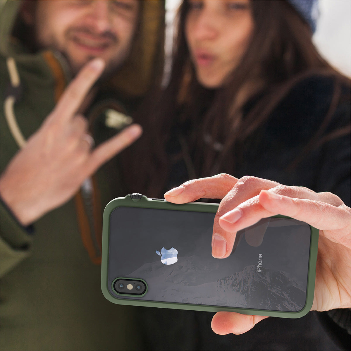 Catalyst Impact Protection Case for iPhone X/XR/Xs/Xs Max showing people using the phone with the catalyst case for selfie outdoor text reads iphone sold separately color shown may differ on the product screen protector not included