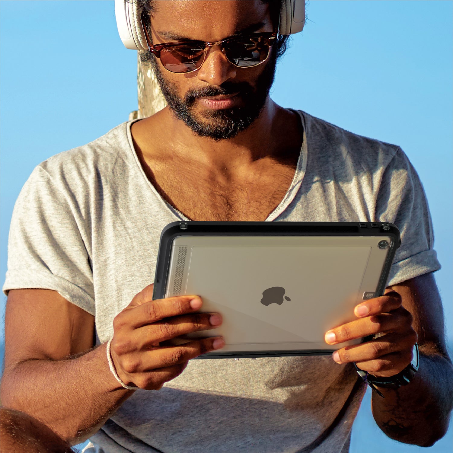 Catalyst ipad (Gen9/8/7), 10.2"-waterproof case showing the man holding the ipad with the case in stealth black colorway