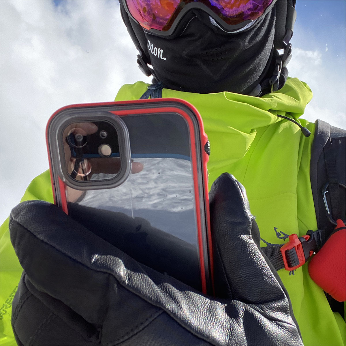 Catalyst iphone 11 series waterproof case in iphone 11 showing the man holding his phone with the case in a flame red colorway. 