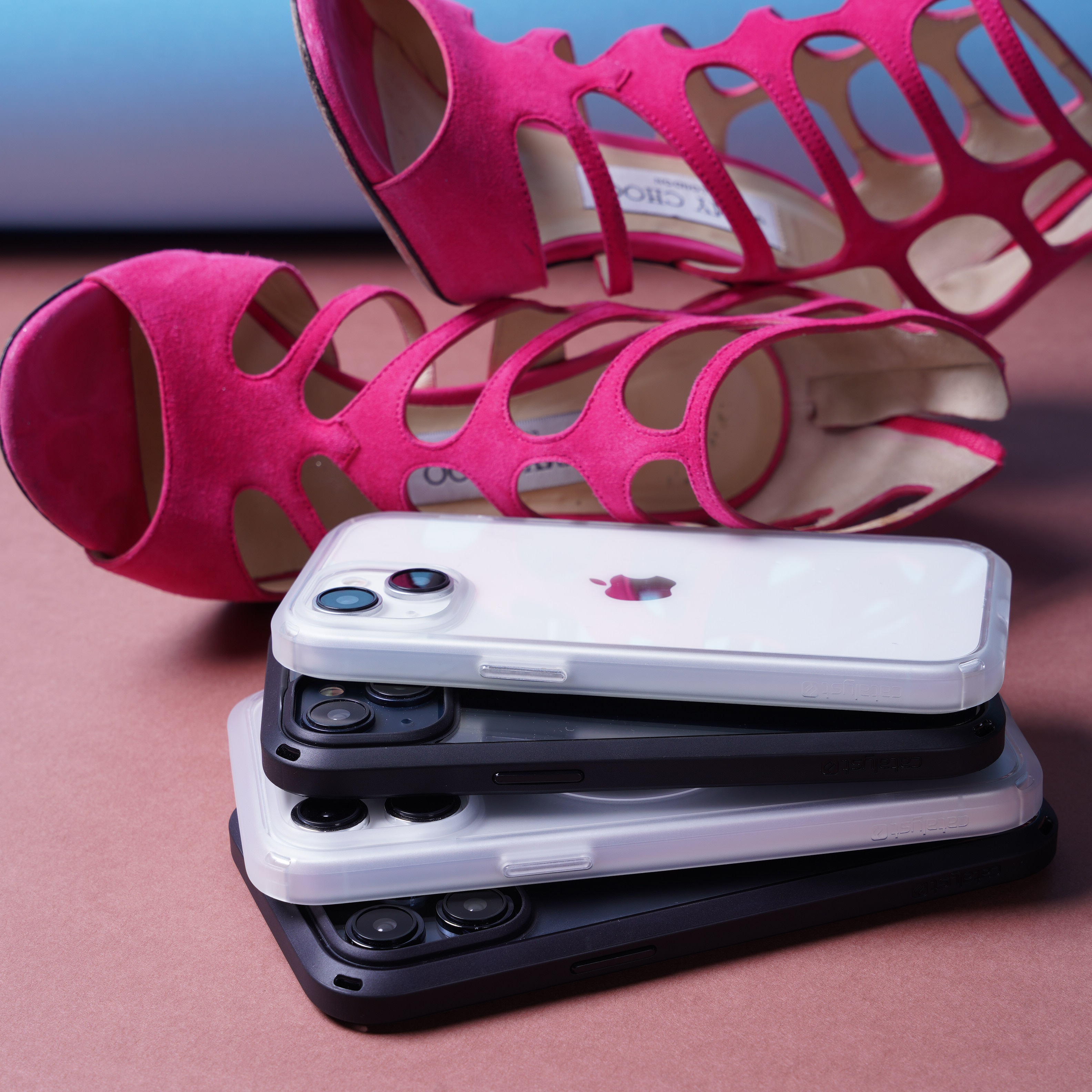 Catalyst iphone 15 series influence case iphone 15 in midnight black and clear colorway with Jimmy Choo hot pink high heels