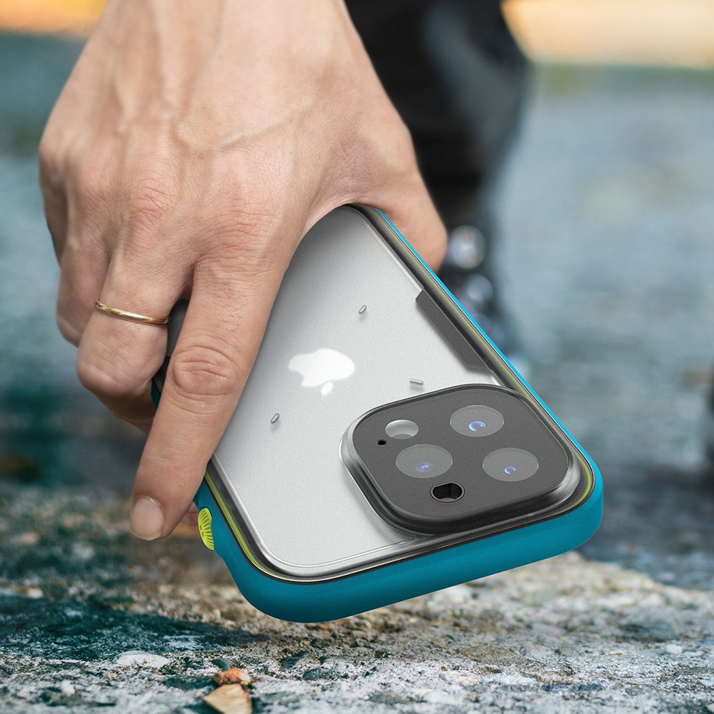 Catalyst Waterproof Total Protection case for iPhone 13 series showing a hand picking up the iphone with the catalyst total protection case installed